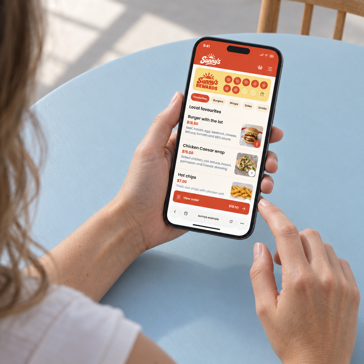 Illustrative woman browsing Sunny’s online food menu on her phone at home