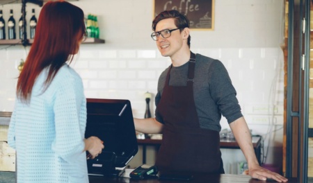 Barista Taking A Customer's Order At A Café Counter
